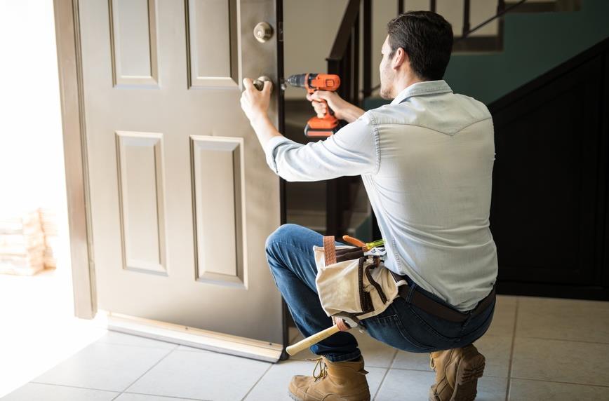 Door installer fitting a new entry door