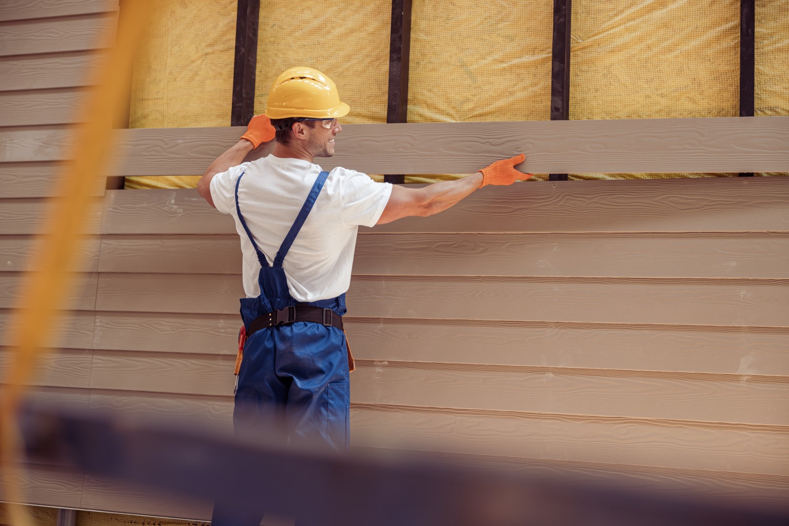 Siding installer working on a home exterior